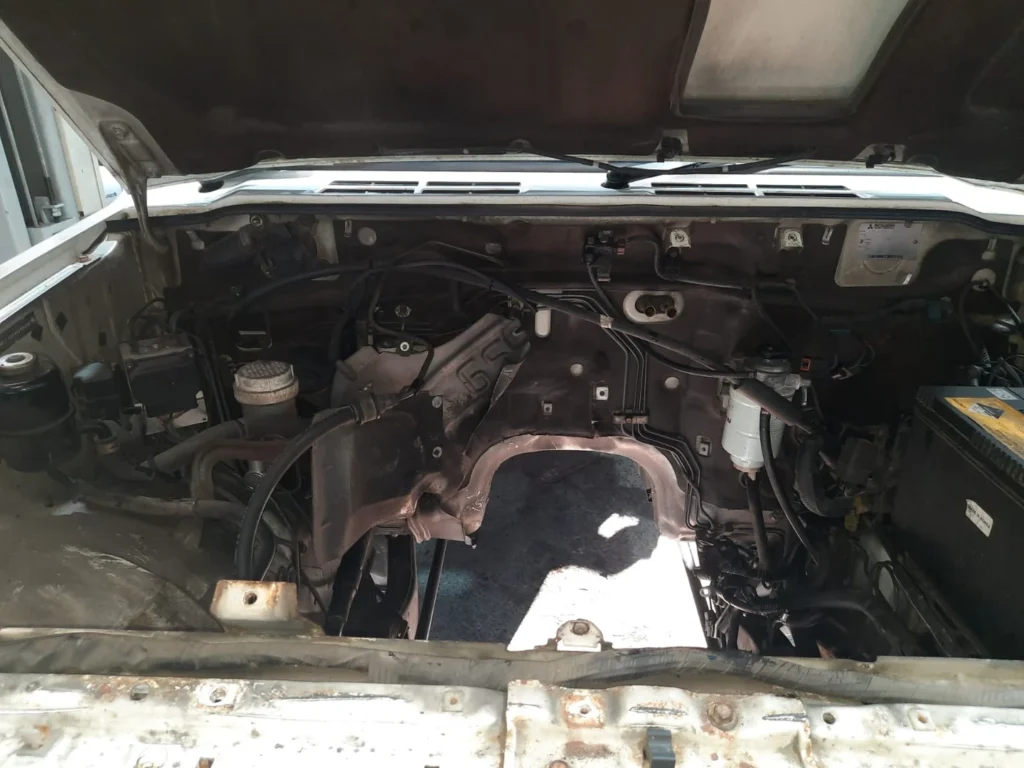 Disassembled Mitsubishi diesel engine components inspected for wear