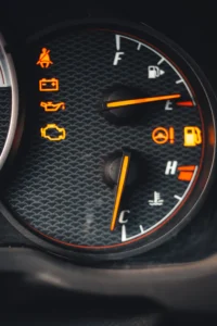 Detailed close-up of car dashboard with various warning lights illuminated.